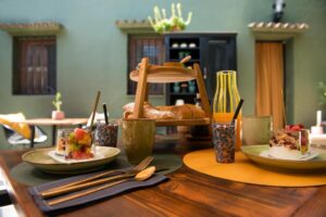 petit déjeuner d'hôtes avec du yaourt, granola, pain, fruits frais, ... pris sur la terrasse