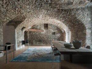 salle voûtée en pierre apparente dans un ancien presbytère transformé en hôtel
