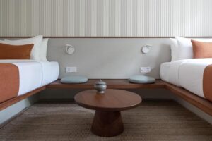 table de chevet reliant les 2 lits dans une chambre