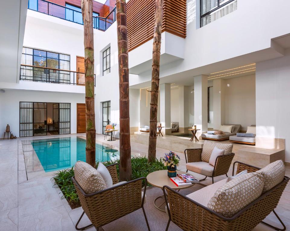 patio avec piscine, salon et transat dans un hotel de luxe au centre de Marrakech
