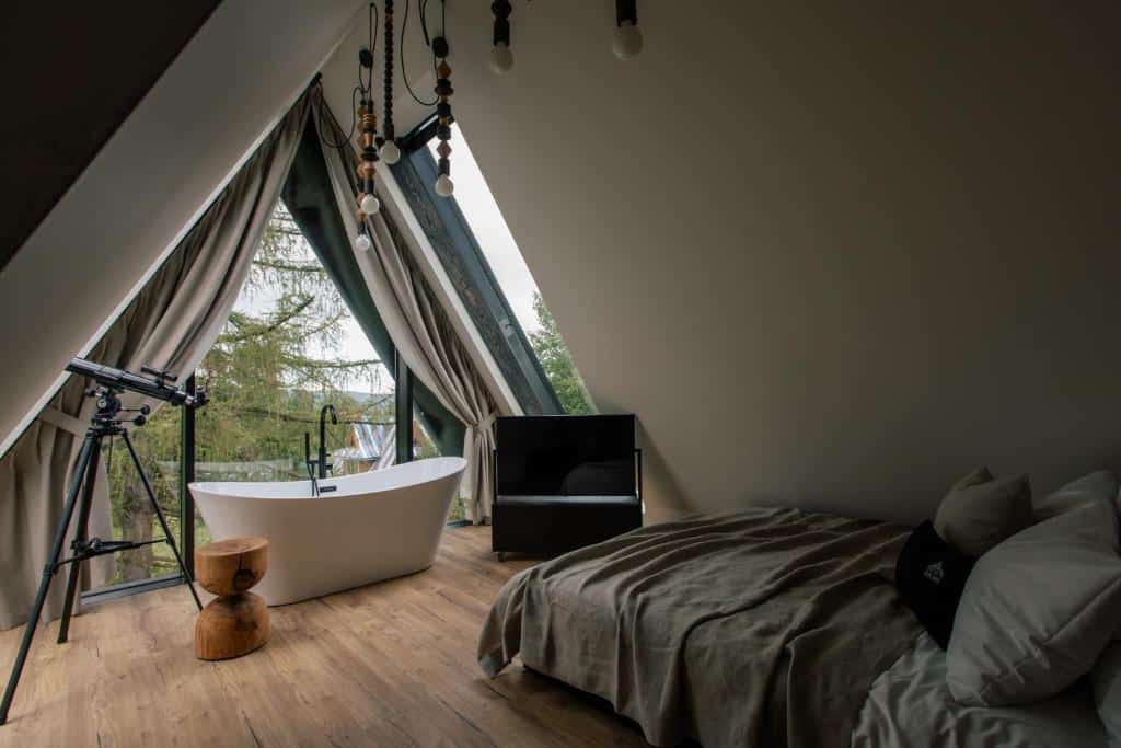 chambre romantique, cosy et chaleureuse avec de grandes baies vitrées pour admirer le panorama extérieur